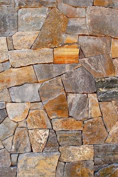 a stone wall made up of many different colored stones