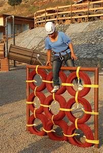 a man sitting on top of a giant piece of art made out of red and yellow circles