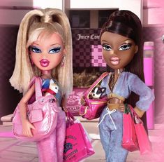 two dolls are standing next to each other holding shopping bags and purses in their hands