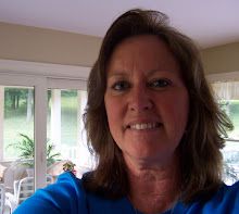 a woman in a blue shirt is smiling