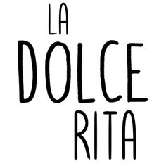 the words la dolce rita written in black ink