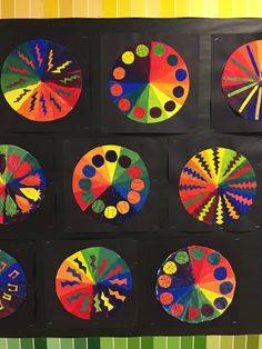 a group of different colored circles on a black board