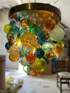 a multi colored chandelier hanging from a ceiling