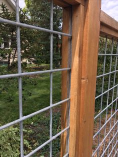 the side of a wooden fence with metal bars