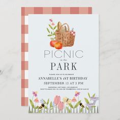 picnic in the park flyer with an image of a basket full of fruit and flowers