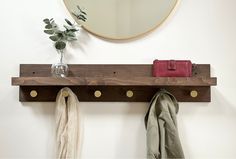 a mirror and coat rack on the wall