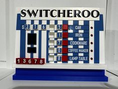 a blue and white machine with numbers on it's front panel, which reads switcheroo