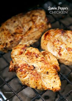 three pieces of chicken cooking on a grill with the words lemon pepper chicken written above it