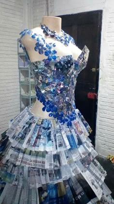 a dress made out of newspapers on display