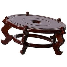 a wooden tray with two legs and a circular design on the top, sitting on a white background