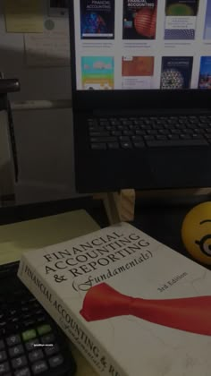 a book sitting on top of a desk next to a keyboard