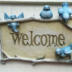 a welcome sign with blue birds on it