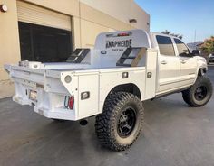 a white truck parked in front of a building