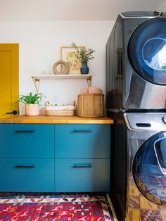 a washer and dryer sitting next to each other in a room with yellow doors