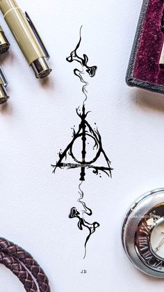 harry potter's deathly hall symbol is shown on the wall next to some pens and