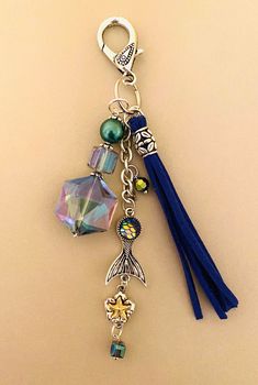 a tasseled keychain with charms and beads on it's side