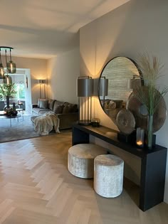 a living room filled with furniture and a large mirror on top of a wooden table