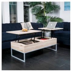 a living room filled with furniture and a laptop computer on top of a coffee table