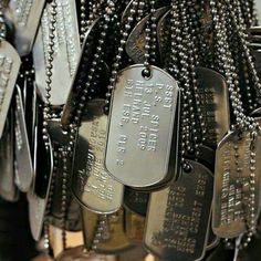 several dog tags are hanging from a chain