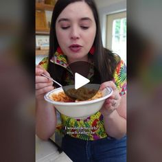 a woman holding a bowl of food and looking at the camera