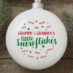 a ceramic ornament with the words grandma and grandpa's little snowflakes on it