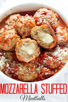 meatballs covered in marinara sauce and parmesan cheese are served in a white bowl