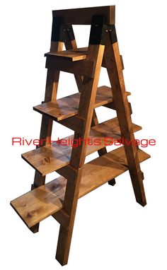 a wooden shelf with three shelves on each side and two levels above the bottom that hold books