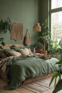 a bed with green sheets and pillows in a room filled with potted plants on the wall