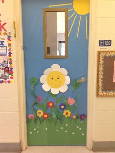 a door decorated to look like a flower with a smiling face on it and flowers in the grass