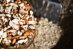 a bowl filled with nuts sitting on top of a table