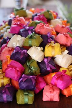 many different colored bows sitting on top of a wooden table