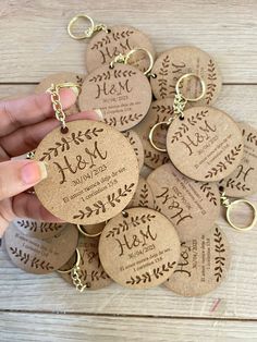 a hand holding a bunch of personalized wine cork key chains