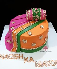 this is a cake with three different colors and designs on the top one has gold, green, and pink