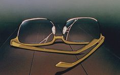 a pair of yellow glasses sitting on top of a wooden floor next to each other