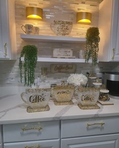 the kitchen counter is decorated with gold and white dishes