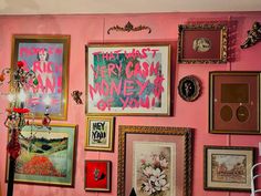 there are many framed pictures on the wall with pink paint and gold trimmings