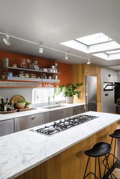 a kitchen with an oven, stove and counter top in the middle of it's center island