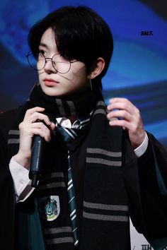 a young man wearing glasses and a scarf