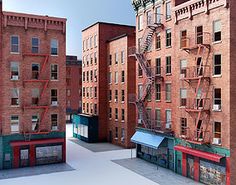 three buildings with fire escapes on the roof