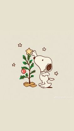 a snoopy christmas tree with a star on it and a dog holding the top