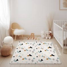 a baby's room with a white crib, rocking chair and teddy bear