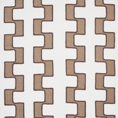 a white and brown fabric with small squares on it