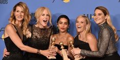 four women posing with their golden globes