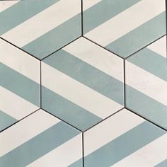 a close up view of some tiles with blue and white stripes on it's sides