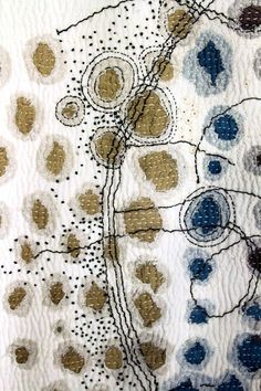 a close up of a piece of cloth with circles and dots on it