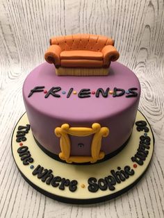 there is a cake that says friends on the top and has a couch on it