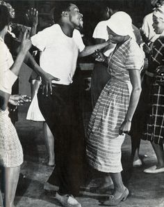 an old black and white photo of people dancing