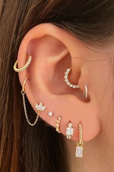 Get inspired by our cute ear piercing ideas for your helix piercing, rook piercing, tragus piercing, conch piercing, forward helix piercing, daith piercing, and multiple ear piercings. Shop gold cartilage earrings at Assolari.co! Different Types Of Ear Piercings, Piercing Girl, Gold Cartilage Earrings, Double Ear Piercings, دورة شهرية, Types Of Ear Piercings, Daith Jewelry, Daith Piercing Jewelry, Tragus Piercing Jewelry