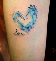 a watercolor tattoo with an origami boat in the shape of a heart