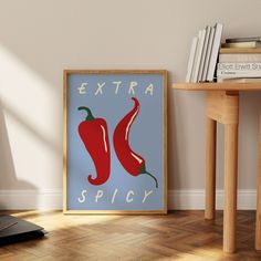 an extra spicy poster on the wall next to a table with books and a laptop